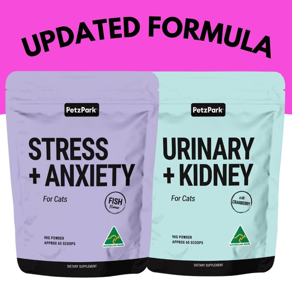 Two PetzPark cat supplement pouches shown side by side on a bright pink background with large black text reading 'UPDATED FORMULA' above. The left pouch is lavender and labeled 'STRESS + ANXIETY' with a fish icon; the right pouch is pale aqua and labeled 'URINARY + KIDNEY' with a cranberry icon.