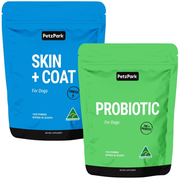 Two dog supplement bags from Petz Park, one labeled 'PROBIOTIC' and the other 'SKIN + COAT', designed for dogs. Both bags are blue with the brand name and product information printed on them.